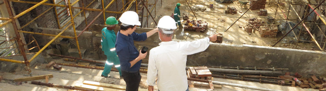 two workers standing on scaffolding at a construction site